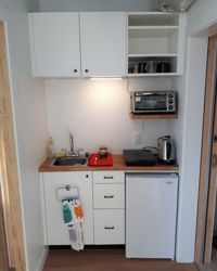 Tiny kitchenette. <br><br>Constructed with modified Ikea cabinets.
