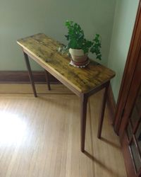 Plant table. <br><br>Top made from reclaimed pine; solid walnut base with mortise and tenon joinery. <br><br>Finished with low-VOC wipe-on urethane.
