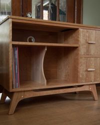 Record Cabinet made from solid cherry wood. <br><br>Oil varnish finish. <br><br>Holds approx 80 LPs, receiver, and drawers fit 45s.